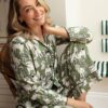 Woman lounging in Cyberjammies Nancy Green Dog Pyjamas – ideal for dog lovers and cozy nights in